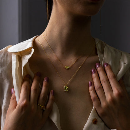 Sweet Pea Moonscape recycled 18ct yellow gold nugget pendant long chain necklace set with white diamond seen on a women necklace layered with a short nugget necklace and matching nugget ring on finger.