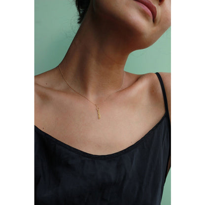 18ct yellow gold Take A Bow necklace with a single circle layered with glistening hanging chains. on model